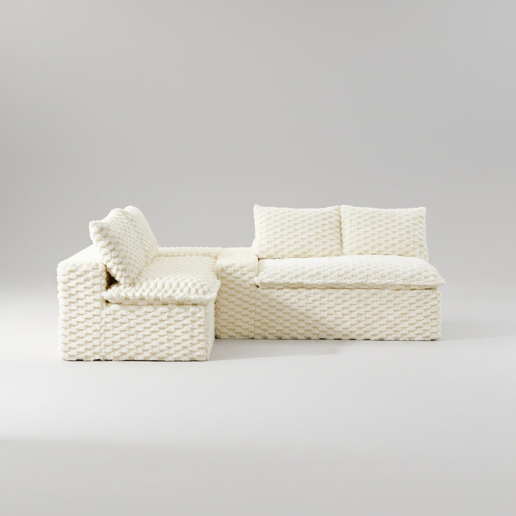 White woven sofa in a living room setting with decor elements.